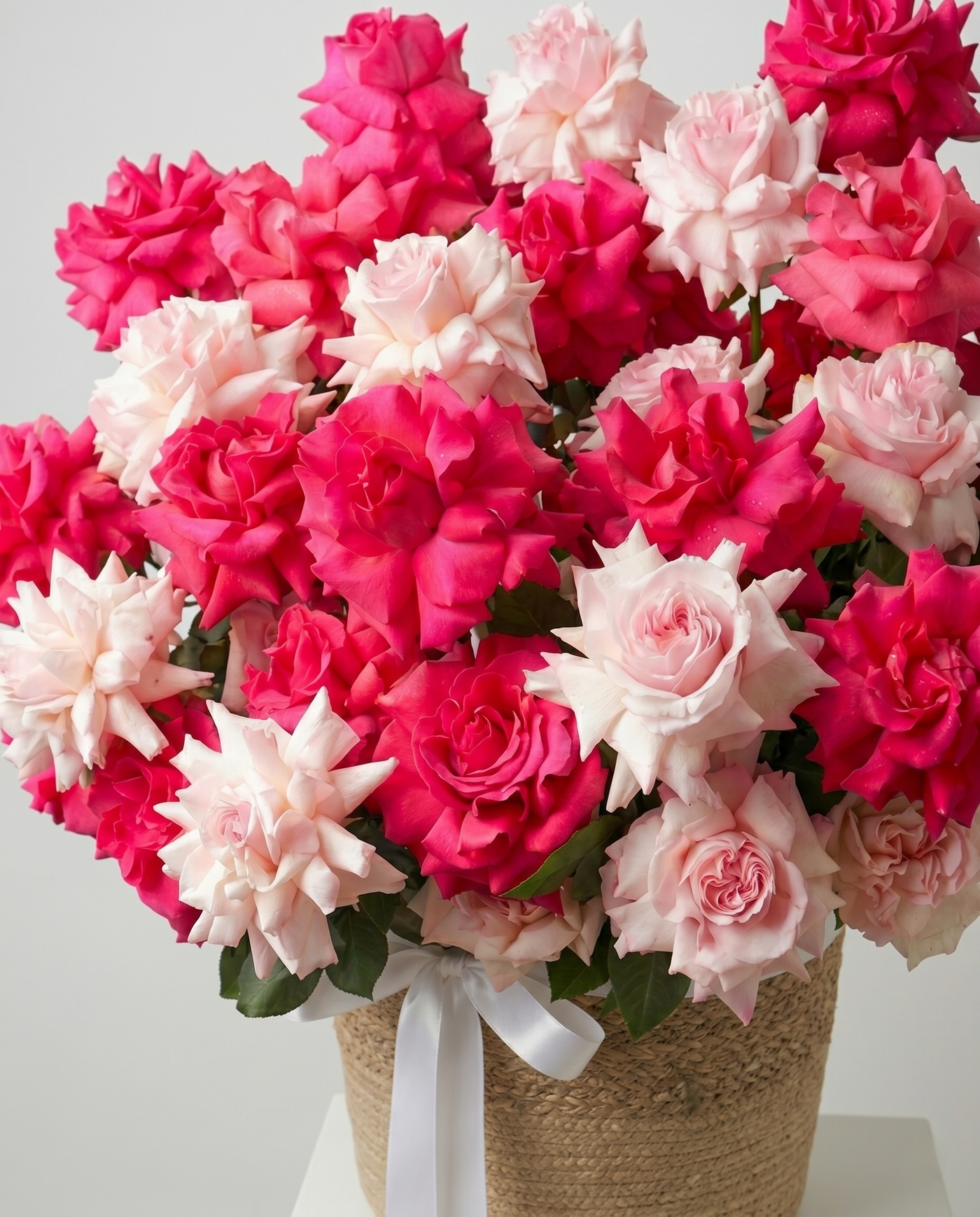 Luxurious French Rose Fuchsia & Blush in Wicker Basket close-up arrangement